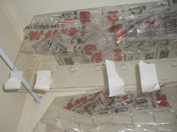 Taping the sides together to hold it while the glue sets